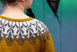 The cardigan is knitted seamlessly top-down