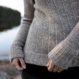 Cuffs and hem are accentuated with folded ribbing