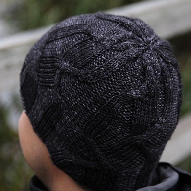 Crown decreases are hidden among the cables