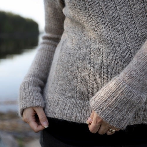 Cuffs and hem are accentuated with folded ribbing